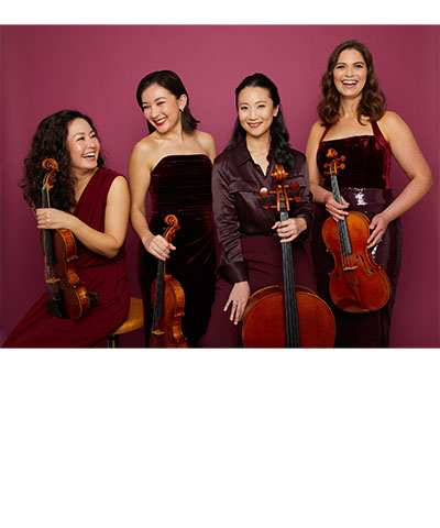 photo of quartet of string musicians holding their instruments against a maroon backdrop