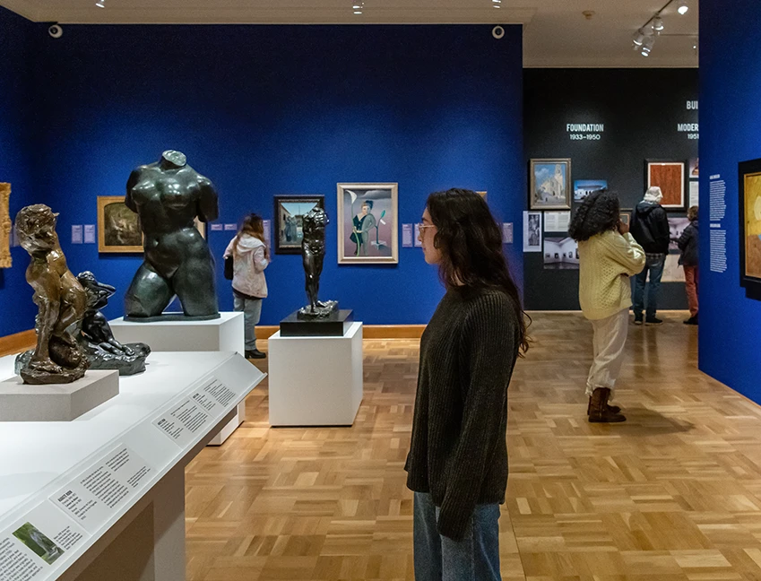patrons in a gallery looking at artwork