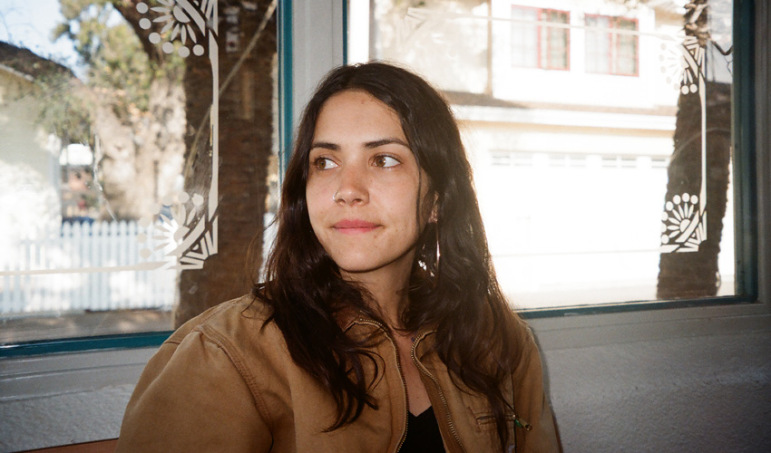 photo of woman in front of a window looking away from camera