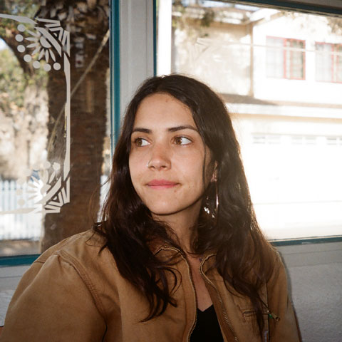 photo of woman in front of a window looking away from camera