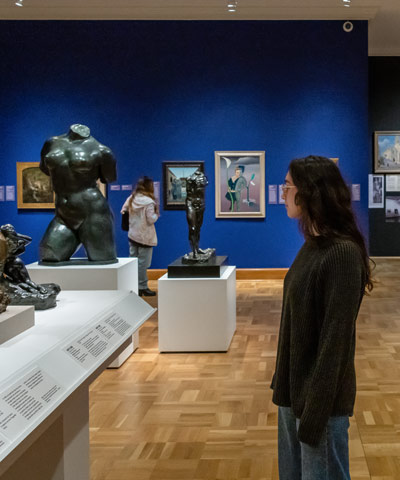 patrons in a gallery looking at artwork