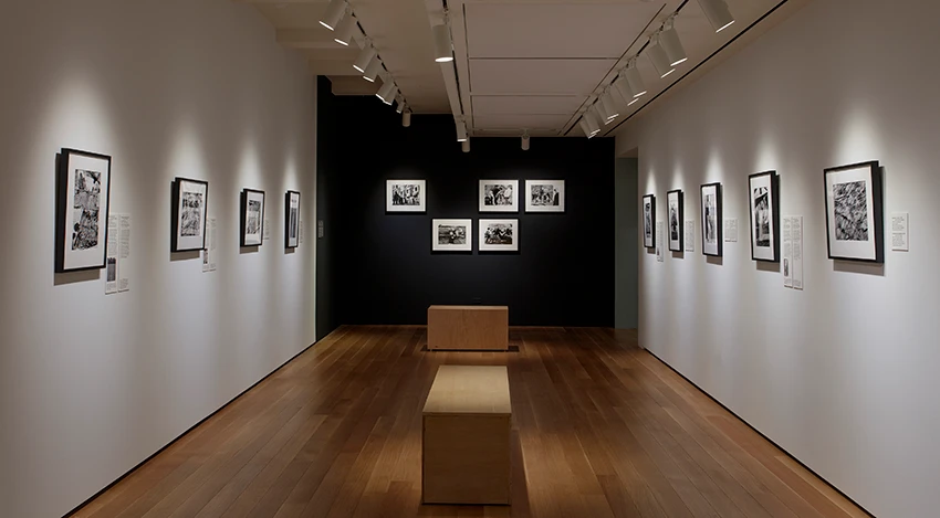 dark gallery with photos on the white walls