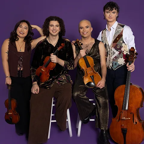 photo of four musicians seated and standing and holding their string instruments against a purple backdrop
