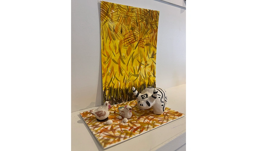 photo of craft with orange background and animal figures in the foreground