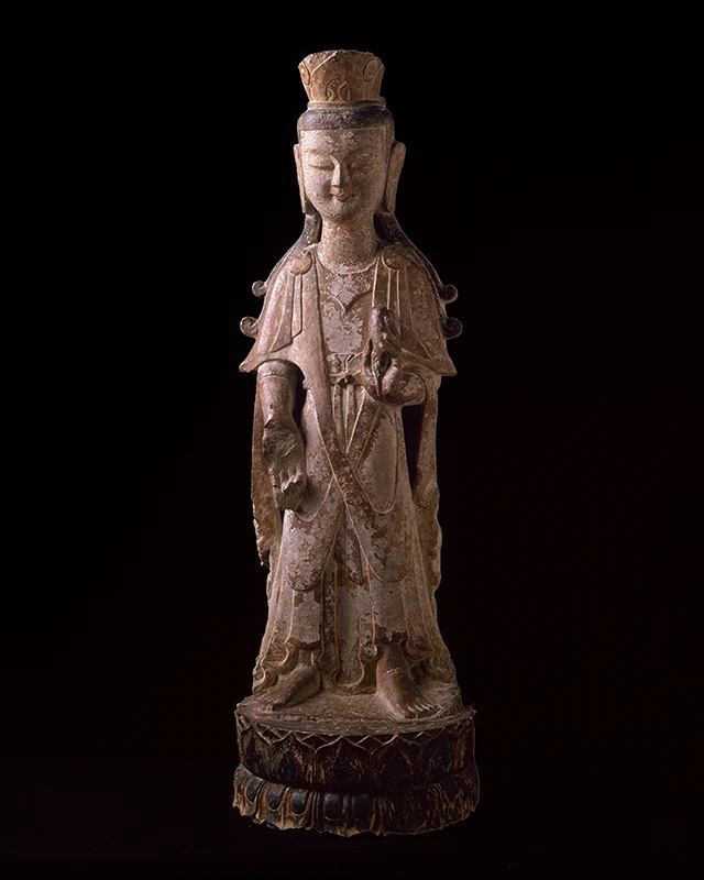 photo of buddha sculpture against a dark background