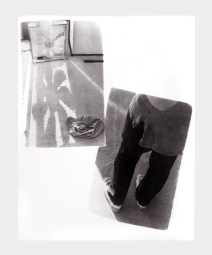 on a gray background a print of two exposures side by side and offset one on top of the other everyday scenes of a carpeted floor and a photo of a person's clothed legs and shoes