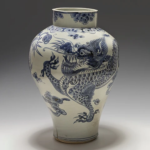 head on photo of a blue and white Chinese vase against a dark gray gradient backdrop