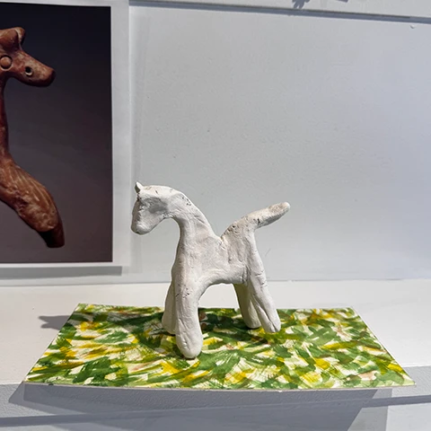 prototype of crafted white clay horse figurine on a base