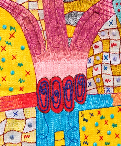 colorful textile full of yellows and reds featuring abstract shapes