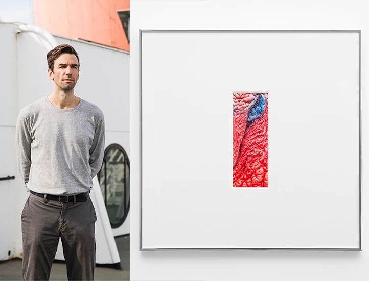 side by side images, on the left a man in casual clothes aboard a ship facing the viewer, and on the right a framed vertical print of a detail of a bird's beak
