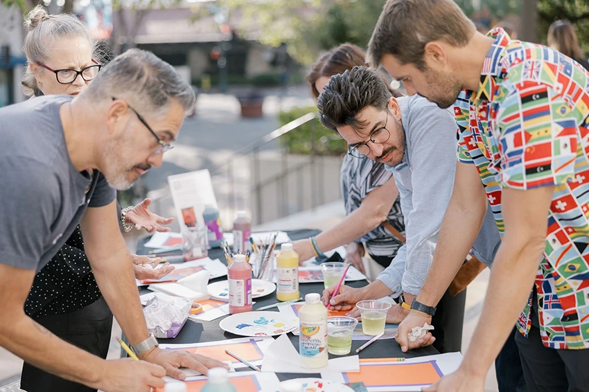adults crafting at a long table