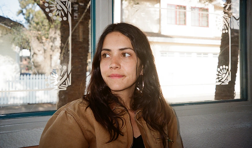 photo of woman in front of a window looking away from camera