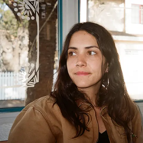 photo of woman in front of a window looking away from camera