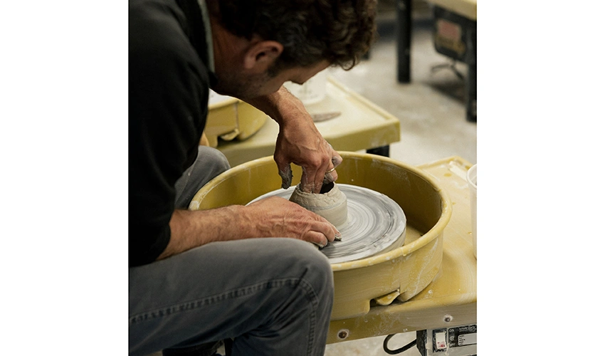 man working at a pottery wheel