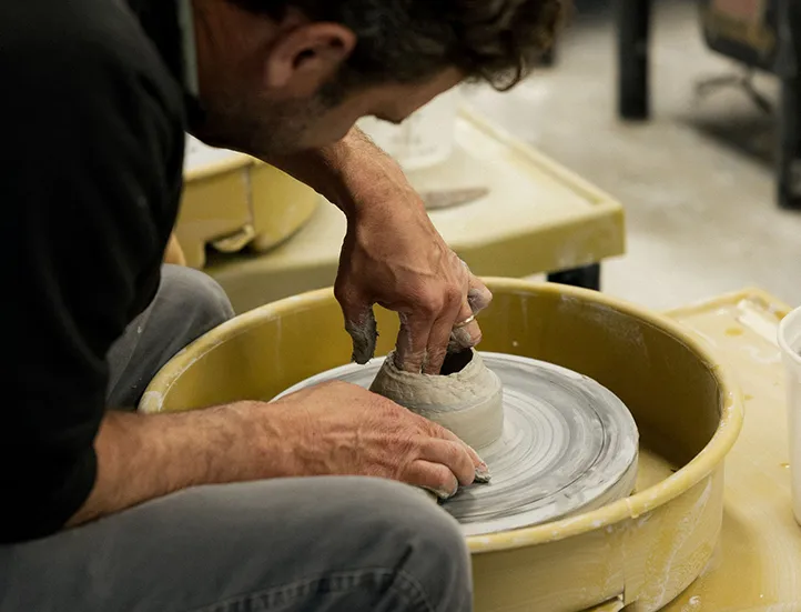 man working at a pottery wheel