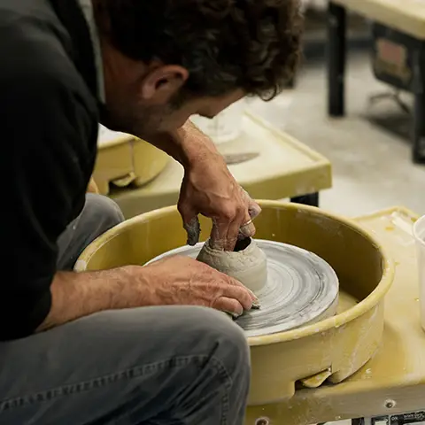 man working at a pottery wheel