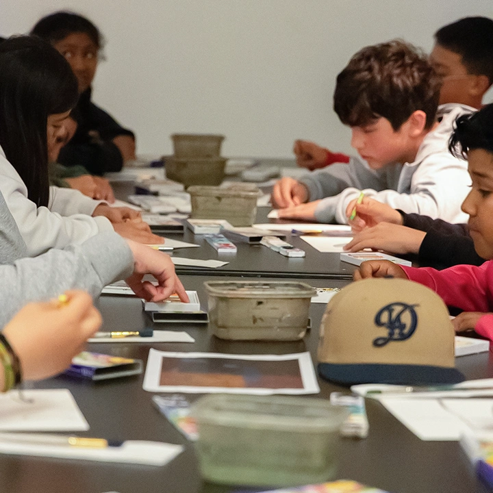 group of young people crafting at a long table