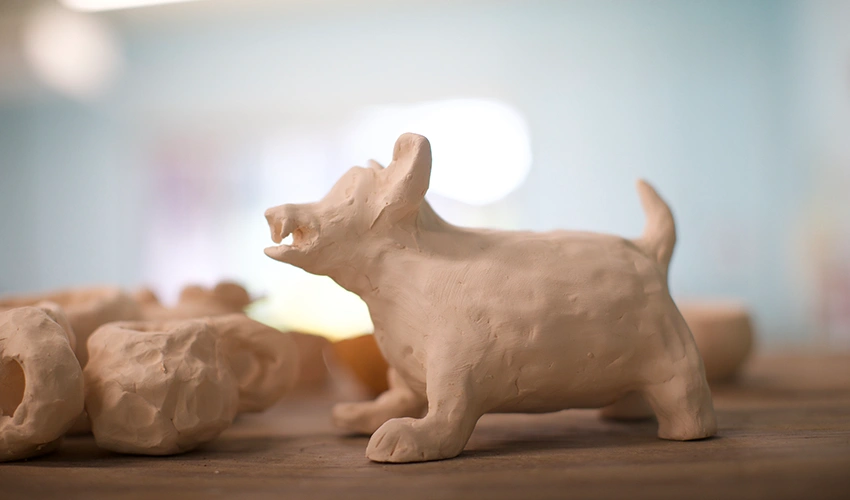 closeup photo of a clay animal, possibly a dog