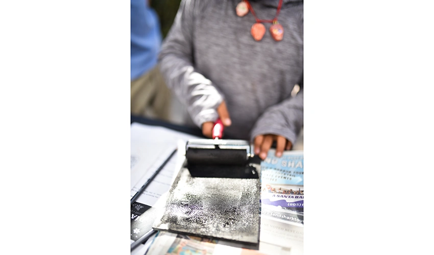 close up of hands working with ink roller
