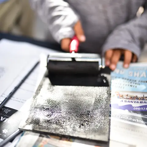 close up of hands working with ink roller
