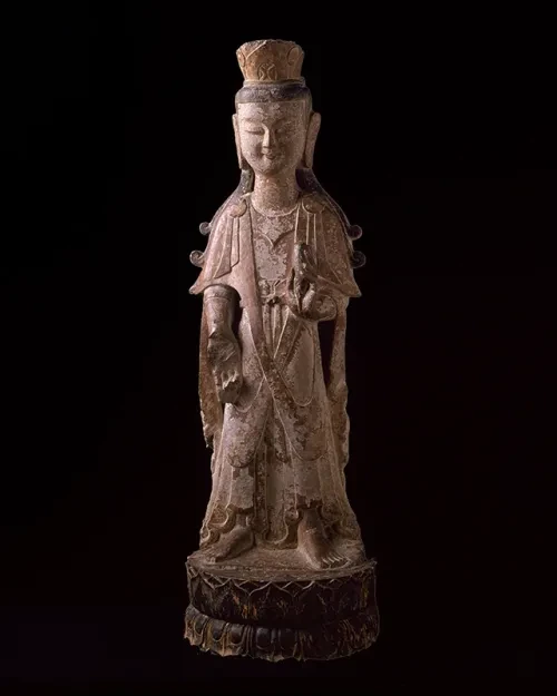 photo of buddha sculpture against a dark background