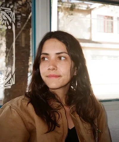 photo of woman in front of a window looking away from camera