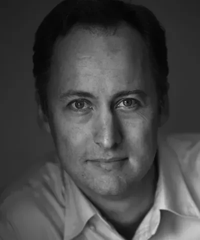 photo of subject with short hair, light skin, and collared shirt looking into lens