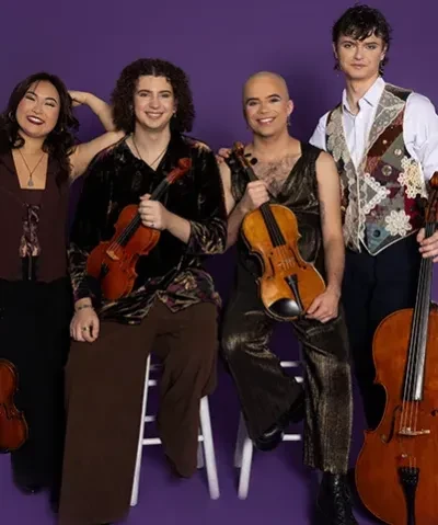 photo of four musicians seated and standing and holding their string instruments against a purple backdrop