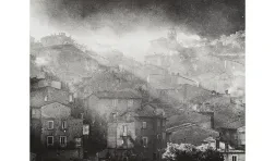 black and white image of rows of brick houses with sunlight filtering through dust behind them