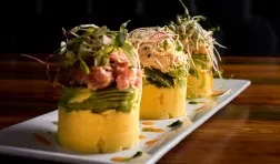Traditional Peruvian dish called Causa made of mashed potato with aji hot pepper and lime juice and filled with vegetables corn, peas, carrots and mayonnaise 