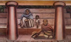 detail of a mural depicting two seated women, and one standing infant, seemingly at the base of exterior steps and flanked by two columns.