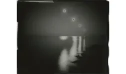 black and white photo of reflections in a body of water receding into the horizon